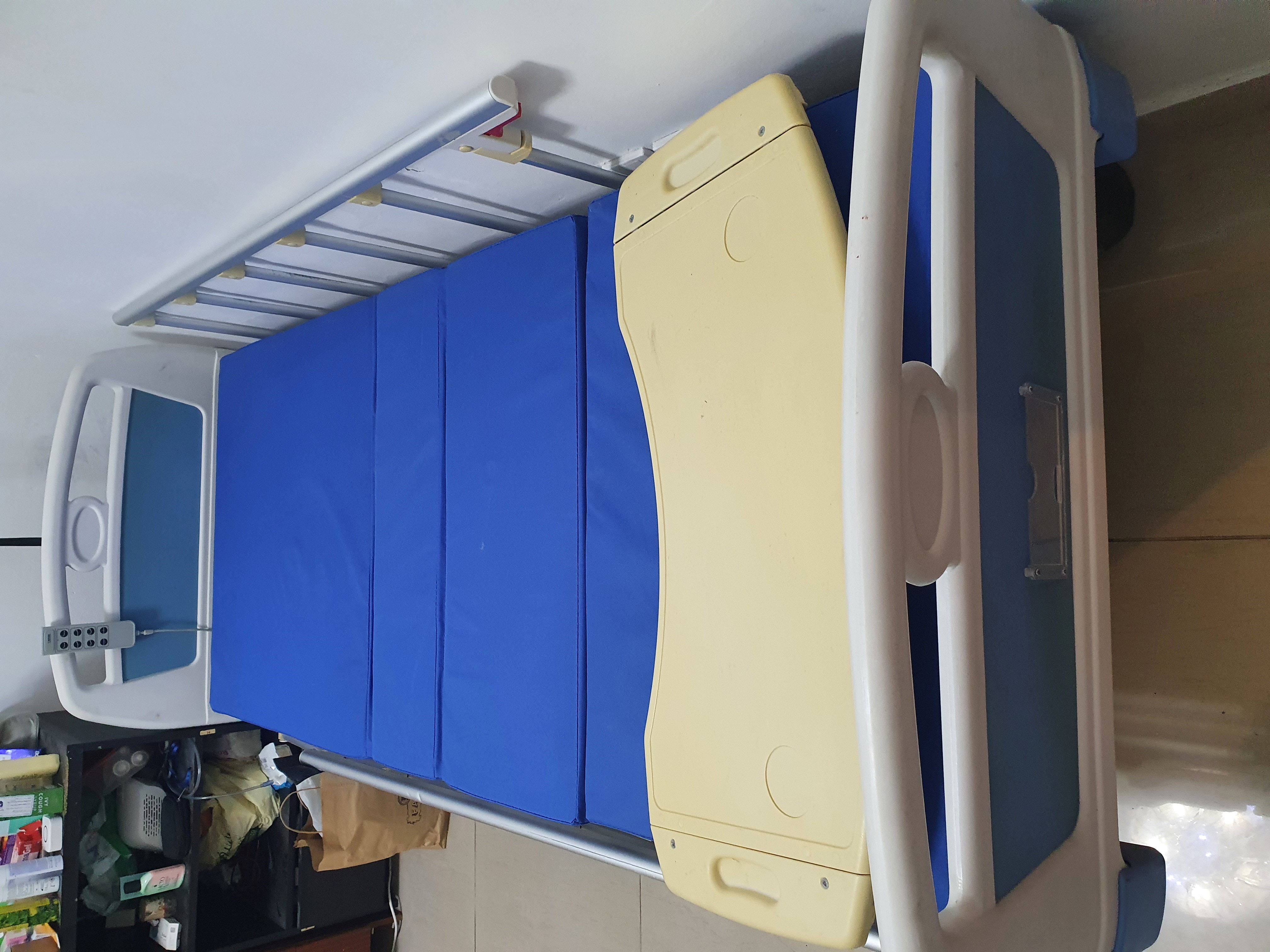 Slightly used four motion Electric Medical bed with mattress and mobile food table