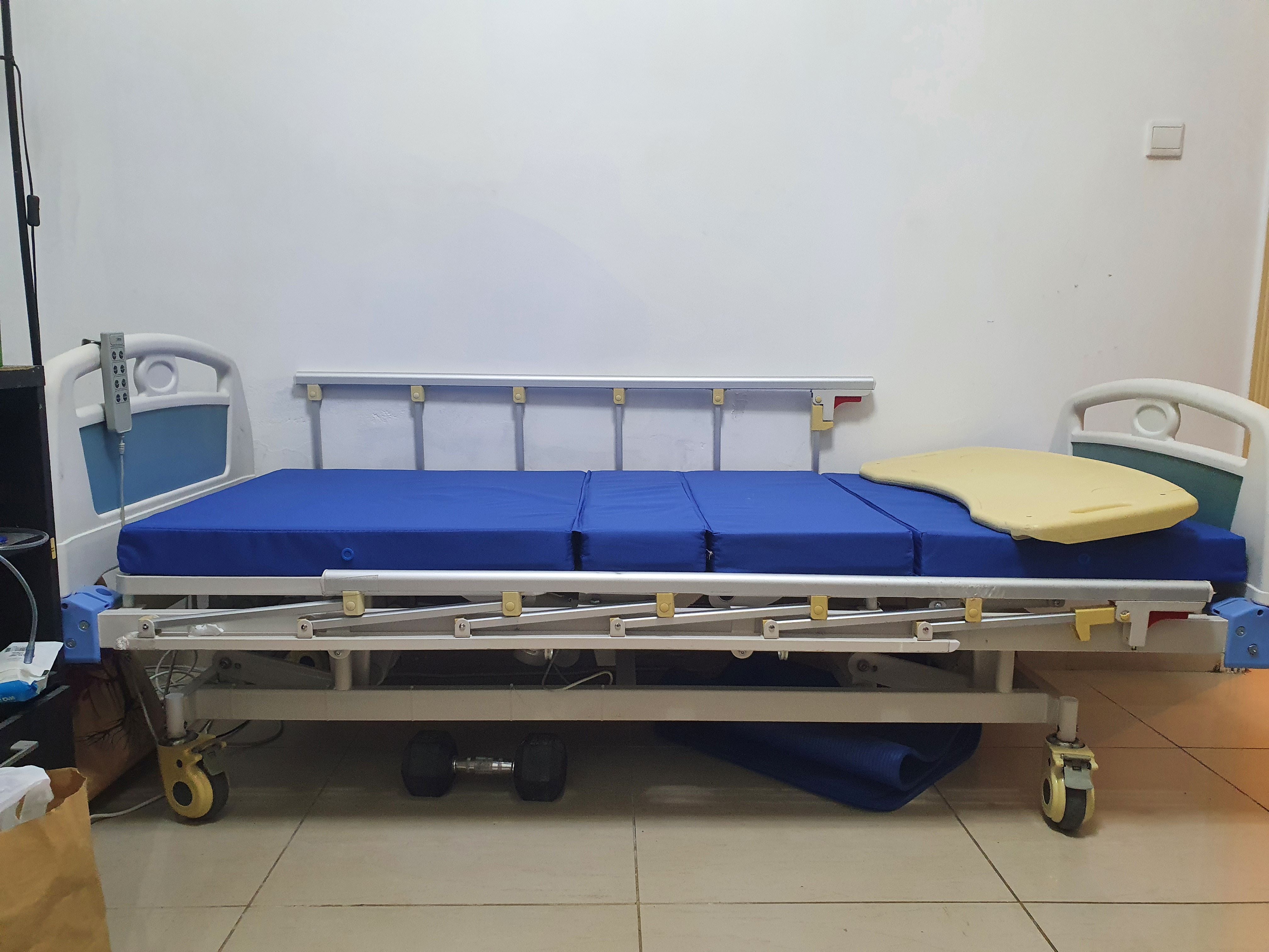 Slightly used four motion Electric Medical bed with mattress and mobile food table